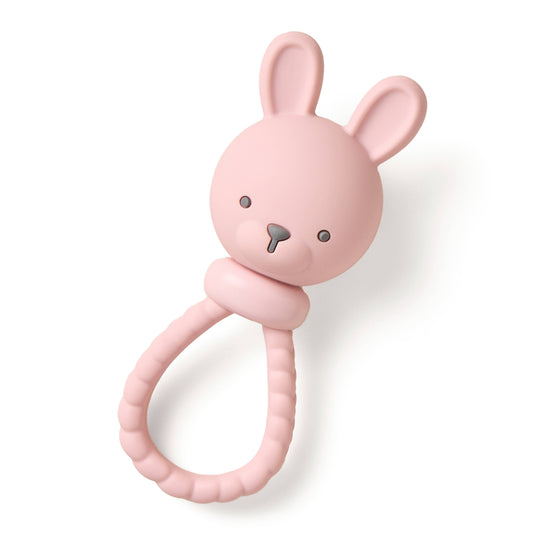 Pink bunny-shaped rattle on a white background
