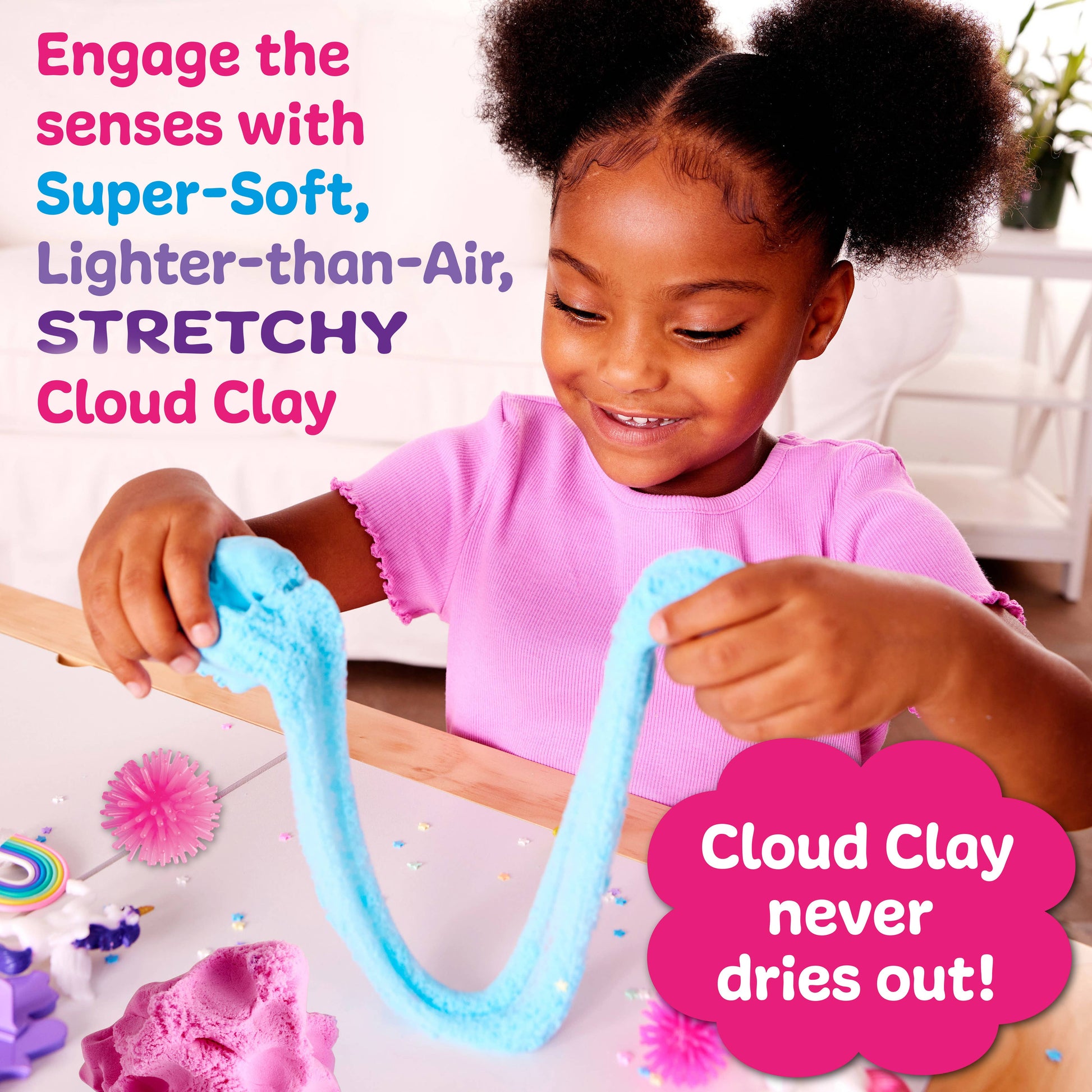 Child playing with blue Cloud Clay, surrounded by colorful decorations.