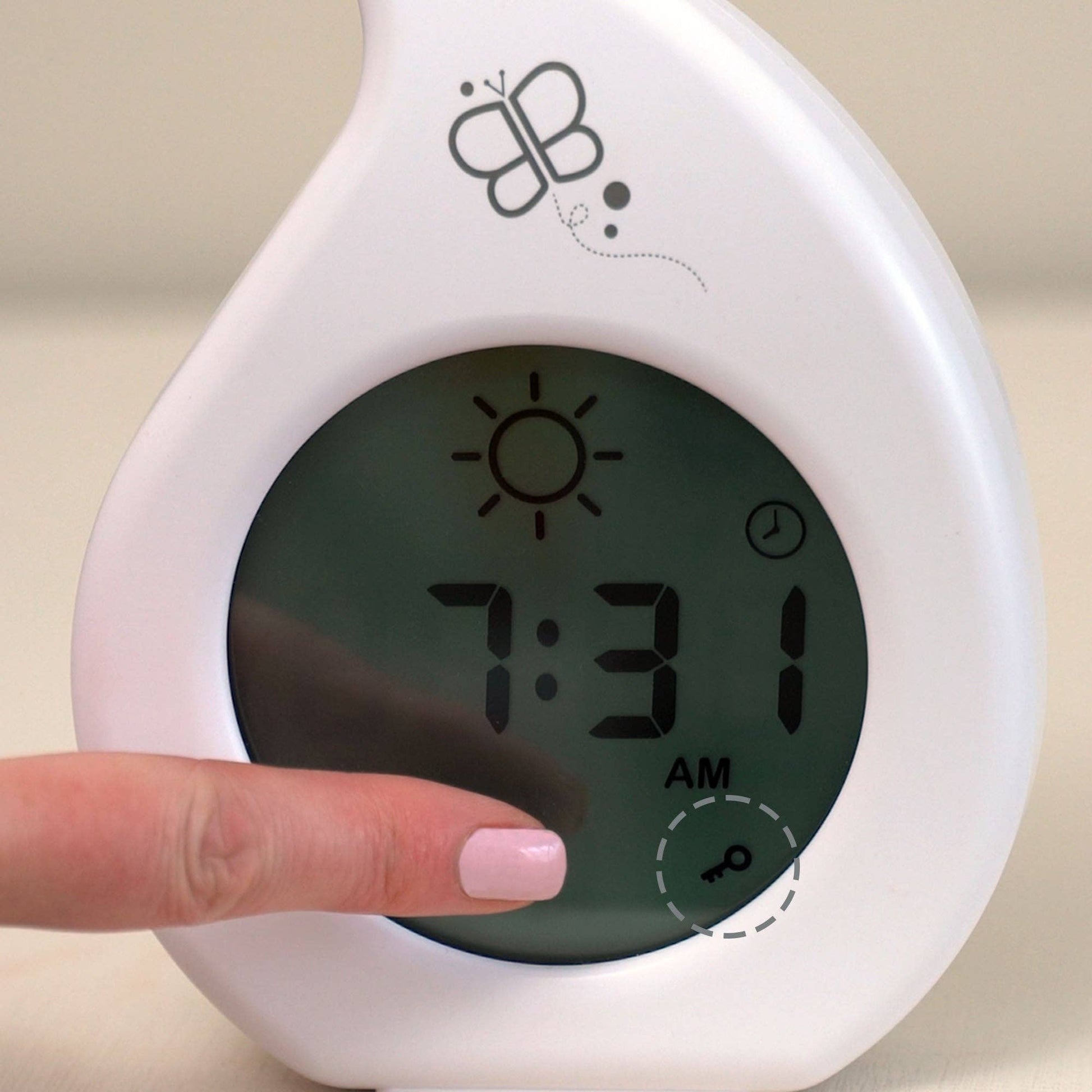 Digital clock with butterfly logo and a hand adjusting the time.
