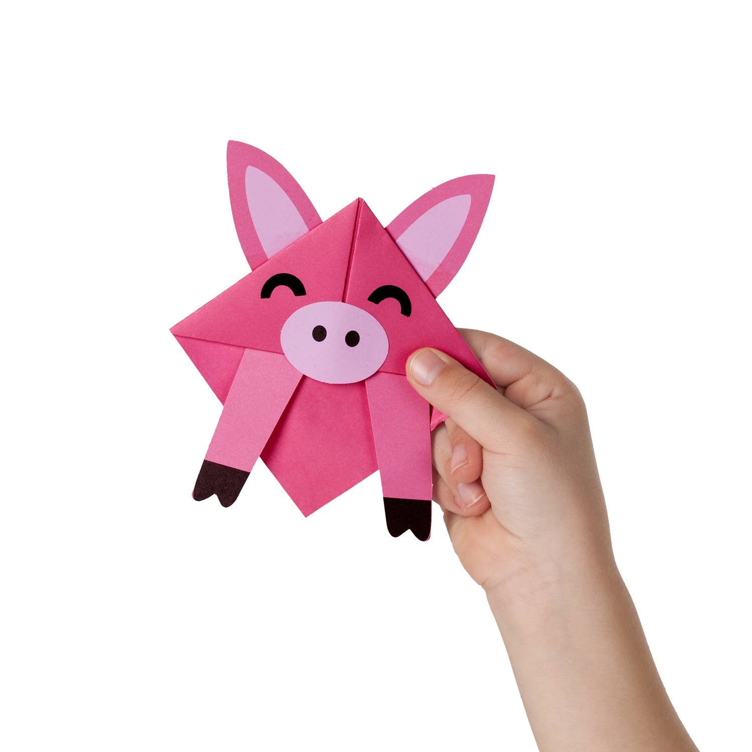 Hand holding a pink origami pig with a white background